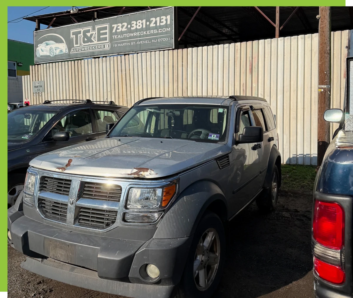 Gray SUV parked in front of dealership.